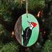 A wood slice with a hand-painted pileated woodpecker available for purchase at Cove Creek Photography.